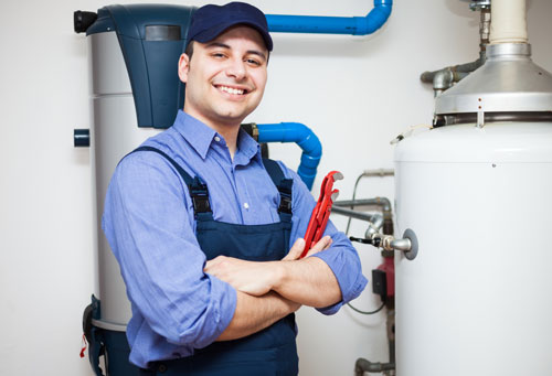 A happy plumber after a successful hot water heater installation.